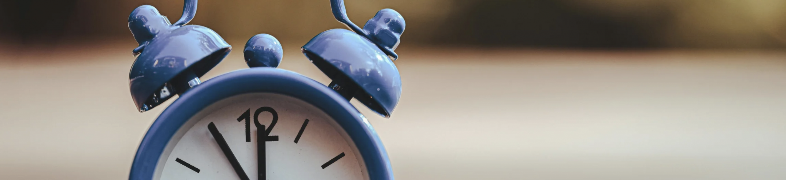Banner image for blue alarm clock representing daylight saving time and the impact of clocks changing on sleep and mental health